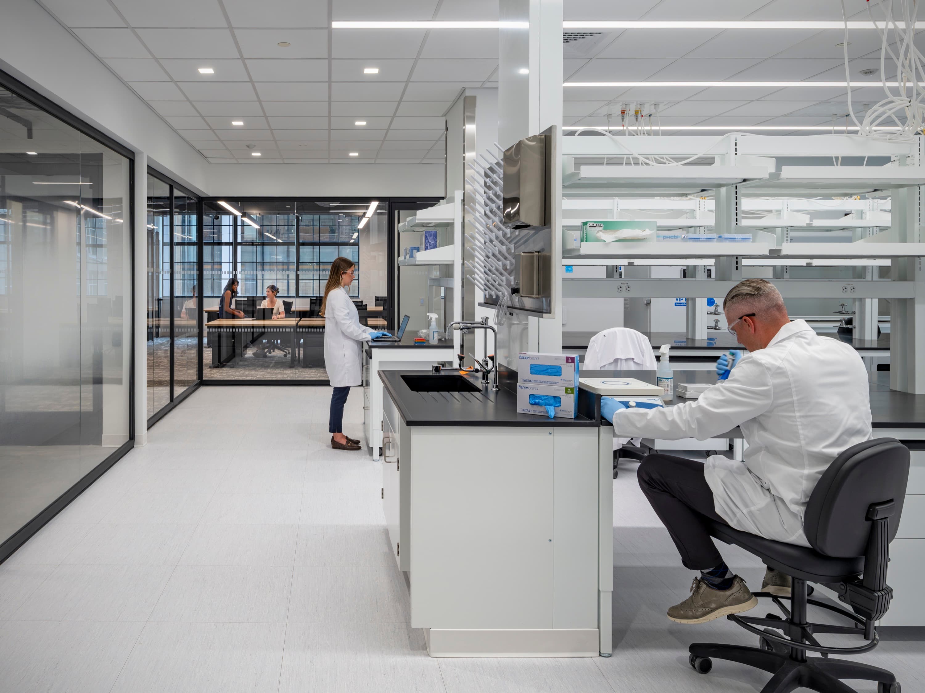 Scientists working at lab benches in the Peptaris laboratory